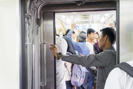 JAKARTA - Indonesia. November 09, 2018: Male passenger using a mobile phone in the train during trip. Shot in Jakarta, Indonesiaのeditorial素材