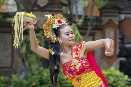 Image of young woman performing traditional Balinese dance in the templeの写真素材