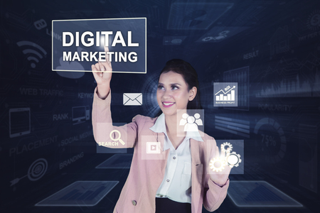 Picture of beautiful business woman pressing digital marketing text on the virtual screenの写真素材