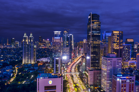 JAKARTA - Indonesia. January 03, 2019: Top view of hectic traffic with office buildings at night time in Jakarta downtownのeditorial素材