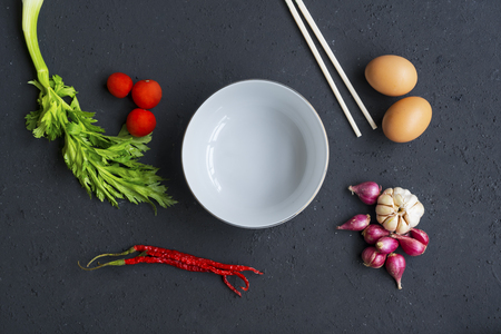Top view of empty bowl with seasoning ingredients over tableの写真素材