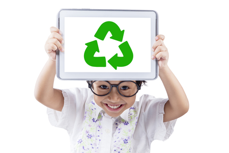 Little girl showing digital tablet screen with recycle symbol, isolated on white backgroundの写真素材