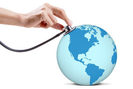 Close up of doctor hand is examining a world globe by using a stethoscope, isolated on white backgroundの写真素材