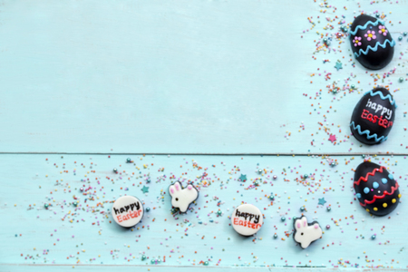 Top view of chocolate eggs and bunnies shaped a frame on the wooden tableの写真素材