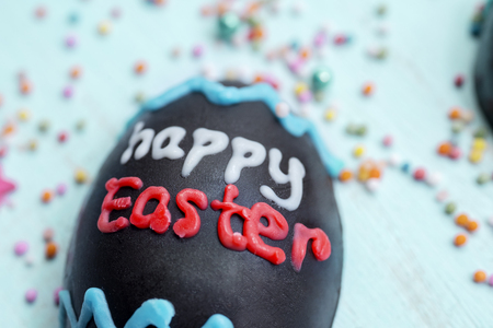 Close up of happy Easter text on a chocolate egg. Easter concept