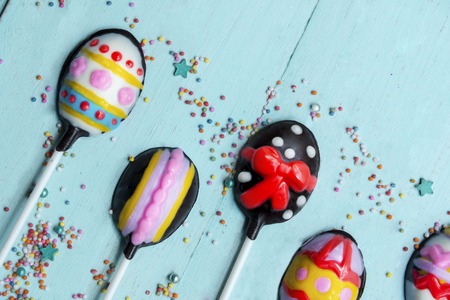 Easter concept. Close up of decorative chocolate Easter eggs candies on the wooden tableの写真素材