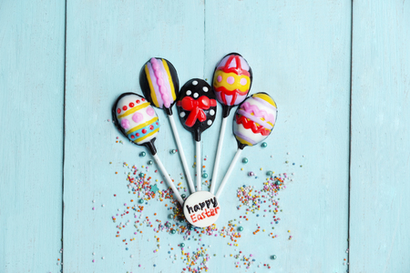 Easter concept. Top view of chocolate easter eggs candy shaped air balloon on the wooden tableの写真素材