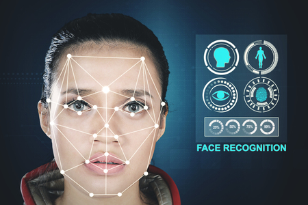 Beautiful woman with a new face recognition technology scanning her face. Face ID concept.の写真素材