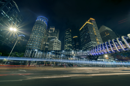 Beautiful Sudirman highway with new pedestrian bridge, skyscrapers, and light trails at night timeのeditorial素材