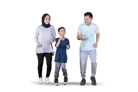 Picture of young Asian family looks happy while doing exercise run in the studio, isolated on white background