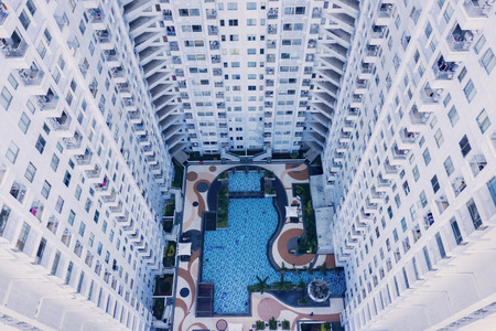 Top down view of modern apartment buildings with a swim pool in Jakarta city, Indonesia