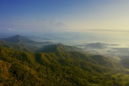 Aerial view of misty mountain at morning time near Ngisis hill, Yogyakarta, Indonesia