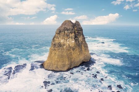 Aerial view of beautiful seascape with big stone on Papuma beach in Jember, Indonesiaの写真素材