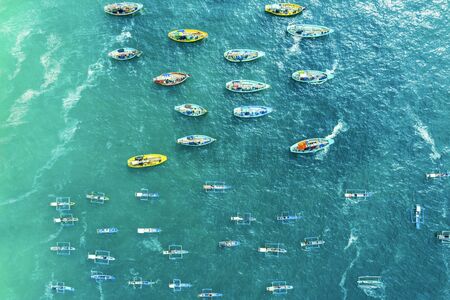 Aerial view of fishing boats sailing on Papuma beach in Jember, Indonesiaの写真素材