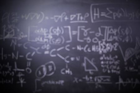 Image of blurred mathematical formulas and doodles on a blackboard backgroundの写真素材