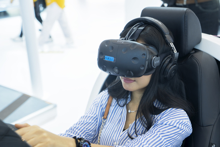 Tangerang - Indonesia. July 24, 2019: Female visitor testing Honda Sensing at event of Gaikindo...
