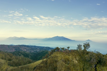 East Java - Indonesia. July 18, 2019: Aerial view of tourists hiking a hill while enjoying Bromo mountain view in East Java, Indonesiaのeditorial素材