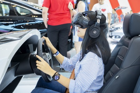 Tangerang - Indonesia. July 24, 2019: Female visitor using Honda Sensing at event of Gaikindo Indonesia International Auto Show (GIIAS) 2019のeditorial素材