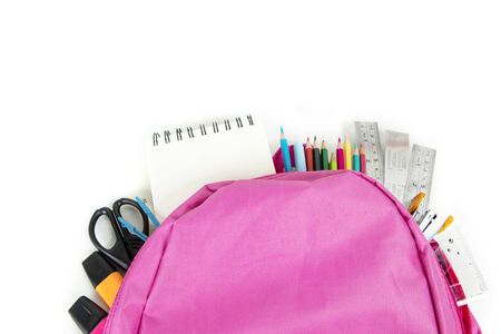 Back to school concept. Top view of a backpack with assorted school supplies, isolated on white...