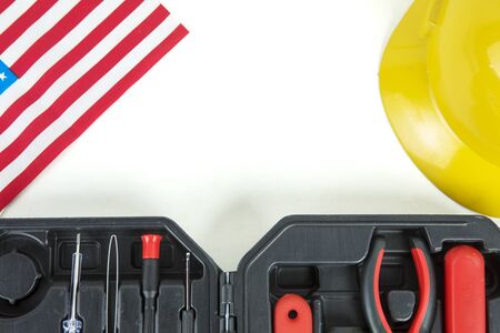 Top view of toolbox with helmet and America flag on the white table. Labor Day conceptの写真素材