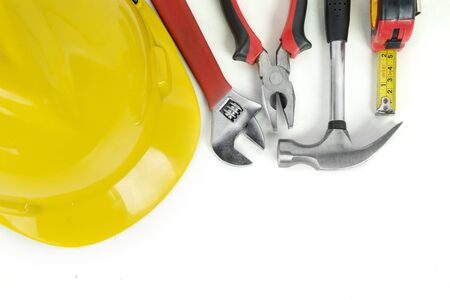 Top view of handy tools with yellow helmet on the table, isolated on white backgroundの写真素材