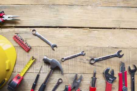 Close up of handy tools and helmet with copy space on the wooden table