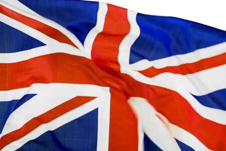 Close up of United Kingdom flag waving in the wind, isolated on whiteの写真素材