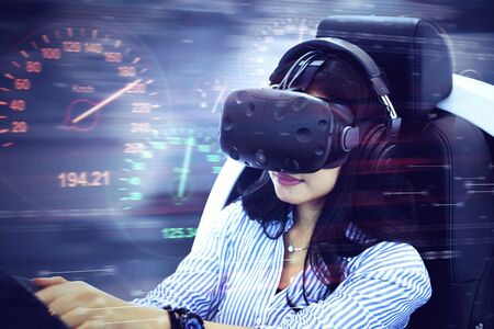 Close up of young woman using a VR glasses to playing a racing game with fast motion blur