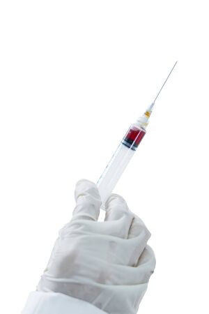 Close up of female doctor hands holding a medical injection in the studioの写真素材