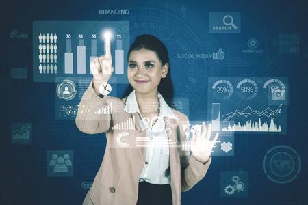 Portrait of pretty businesswoman working with financial chart on virtual screen