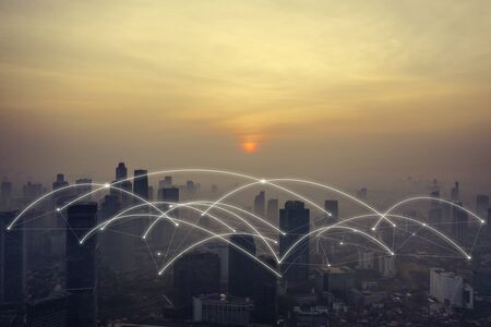 Silhouette of skyscrapers with connection network at dusk time in Jakarta city