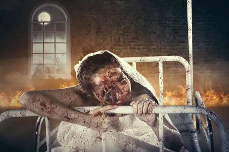 Picture of a creepy female ghost wearing bridal gown while sitting on the bed. Shot in haunted houseの写真素材