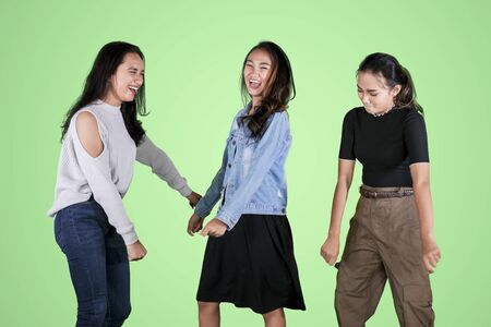 Picture of cheerful young people dancing together by celebrating their success in the studioの写真素材