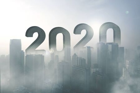 Aerial view of skyscrapers with numbers 2020 in the misty city at morning timeの写真素材