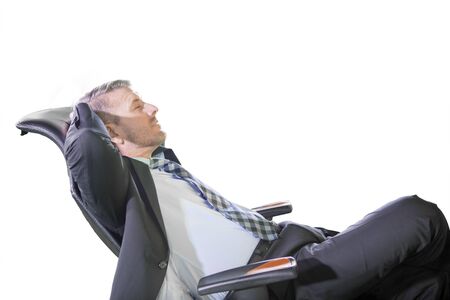 Side view of handsome man relaxing with his hands behind head while sitting on armchair, isolated on white backgroundの写真素材