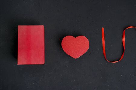 Flat layout of I Love You concept formed by valentine packages and a ribbon, isolated in black wall backgroundの写真素材