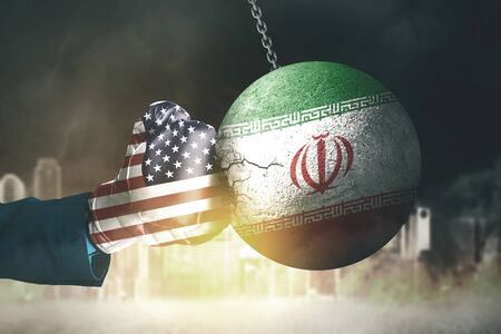 World War 3 illustration concept with USA flag, as a boxing glove punching Iran flag, as a wrecking ball in burning city backgroundの写真素材