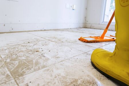 Low angle closeup photo of worker mopping the floorの写真素材
