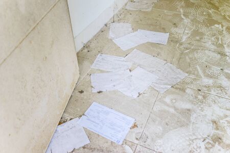 Mails on a dusty floor of an abandoned houseの写真素材