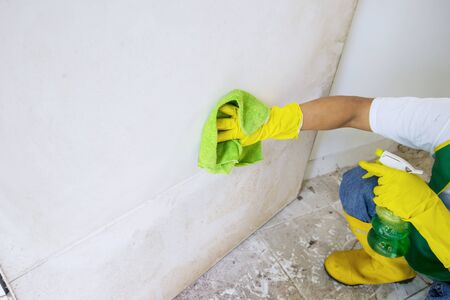 Man cleaning the door using microfiber cloth
