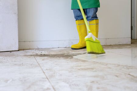 Closeup shot a professional cleaners wearing boots cleaning up a house