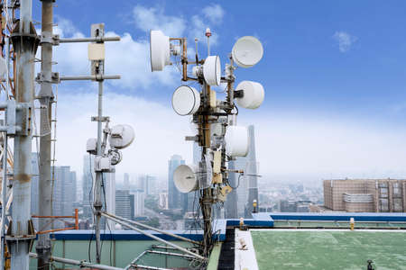JAKARTA, Indonesia - February 14, 2020: Two radio masts on the peak of a building with Jakarta city...