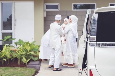 Young Muslim family with kids visiting their parents for Eid Mubarak celebrationの写真素材