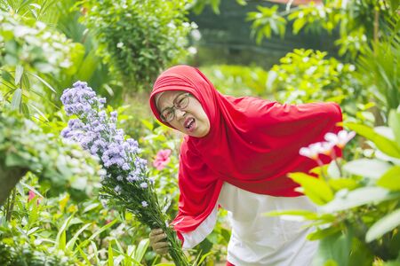 Senior muslim woman getting backache during gardening at the gardenの写真素材