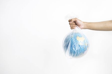 Hand holding globe in plastic bag, isolated on white backgroundの写真素材