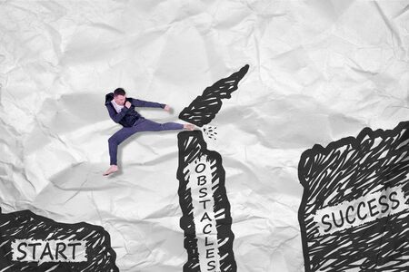 Young man jumping and destroy obstacle to reach the success textの写真素材