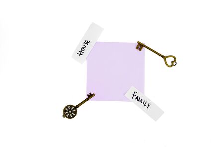 Top view of key house with empty paper and family text, isolated on white background