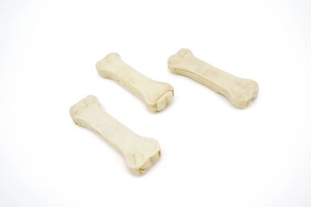 Three bones for dog snack in the studio, isolated on white background