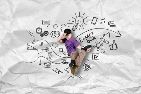 Picture of cool boy jumping while doing break dance with doodles and crumpled paperの写真素材