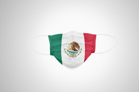 Medical protective mask with flag of Mexico, isolated on white background. Symbolizing Coronavirus disease or Covid-19 in Mexico.の写真素材